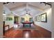 This game room has a pool table, wood floors, a fireplace, and large windows that let in natural light at 3417 E Mission E Ln, Phoenix, AZ 85028