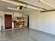 Spacious garage with epoxy floors, storage cabinets, and a workbench at 3417 E Mission E Ln, Phoenix, AZ 85028