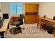 Spacious office with carpeted floor, natural wood furniture, and a large window at 3417 E Mission E Ln, Phoenix, AZ 85028