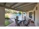Covered patio featuring outdoor seating, tiled flooring, and views of the pool and garden at 3417 E Mission E Ln, Phoenix, AZ 85028