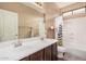 Bathroom featuring a double sink vanity, shower-tub combo, toilet, and mirror, offering modern convenience at 3680 S Tower Ave, Chandler, AZ 85286