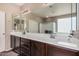 Spacious bathroom with double sinks, a large mirror, wood cabinets, and a separate shower area at 3680 S Tower Ave, Chandler, AZ 85286