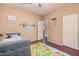 Bright bedroom with wood floors, natural light, closet, and a colorful play mat enhancing the appeal of the space at 3680 S Tower Ave, Chandler, AZ 85286