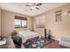 Well-lit bedroom featuring hardwood floors, a ceiling fan, and a comfortable bed at 3680 S Tower Ave, Chandler, AZ 85286