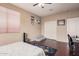 Well-lit bedroom featuring hardwood floors, a ceiling fan, and a comfortable bed at 3680 S Tower Ave, Chandler, AZ 85286