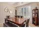 Elegant dining room with modern chandelier, shutters, and dark wood table at 3680 S Tower Ave, Chandler, AZ 85286