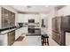 Bright kitchen with stainless steel appliances, granite counters, eat-in island and access to dining at 3680 S Tower Ave, Chandler, AZ 85286