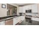 Stylish kitchen with granite counters, stainless steel appliances, modern backsplash, and bright white cabinets at 3680 S Tower Ave, Chandler, AZ 85286