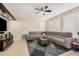 Gathering room with a ceiling fan and large sectional sofa at 3680 S Tower Ave, Chandler, AZ 85286