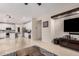 Spacious living room featuring neutral colors, tile floors, and a view into the open kitchen at 3680 S Tower Ave, Chandler, AZ 85286