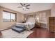 Well-lit bedroom featuring hardwood floors, king bed, and a comfy rug at 3680 S Tower Ave, Chandler, AZ 85286