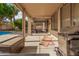 Covered patio with a grill, outdoor furniture, and view of the pool area, perfect for outdoor entertaining at 3680 S Tower Ave, Chandler, AZ 85286