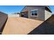 Large backyard with covered patio, block wall, and expansive dirt area awaiting your landscaping ideas at 37357 W San Sisto Ave, Maricopa, AZ 85138