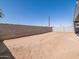 Large backyard with block wall fencing, ideal for outdoor activities and customization at 37357 W San Sisto Ave, Maricopa, AZ 85138