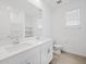 Bathroom featuring dual sinks, ample counter space and cabinets, and modern fixtures at 37357 W San Sisto Ave, Maricopa, AZ 85138