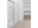 The bathroom has a glass enclosed shower, neutral tile, and a view into the walk-in closet at 37357 W San Sisto Ave, Maricopa, AZ 85138