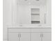 Bathroom showcases double vanity sinks, a large mirror, and white cabinetry at 37357 W San Sisto Ave, Maricopa, AZ 85138