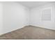 Neutral bedroom with cozy carpeting, white walls, and a bright window at 37357 W San Sisto Ave, Maricopa, AZ 85138