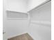 Walk-in closet with carpet flooring, white walls, and ample shelving at 37357 W San Sisto Ave, Maricopa, AZ 85138