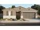 Charming single-story home with a desert landscape, complemented by a neutral-tone exterior and inviting two-car garage at 37357 W San Sisto Ave, Maricopa, AZ 85138