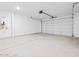 Spacious two-car garage featuring sealed concrete floors and a water heater at 37357 W San Sisto Ave, Maricopa, AZ 85138