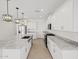 Spacious kitchen with a central island, granite countertops, and modern appliances and cabinetry at 37357 W San Sisto Ave, Maricopa, AZ 85138