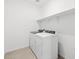 Laundry room featuring modern washer and dryer with white walls and tile floor at 37357 W San Sisto Ave, Maricopa, AZ 85138