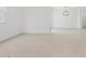 A large living area features neutral tile floors, bright light, and modern lighting fixtures at 37357 W San Sisto Ave, Maricopa, AZ 85138