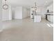 An open-concept home features neutral tile floors and a kitchen with stainless steel appliances at 37357 W San Sisto Ave, Maricopa, AZ 85138