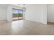 A bright living area features tile floors, modern lighting, and access to the home's exterior at 37357 W San Sisto Ave, Maricopa, AZ 85138