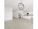 An open concept living area featuring neutral tile floors and a modern kitchen with stainless steel appliances at 37357 W San Sisto Ave, Maricopa, AZ 85138