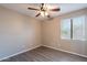 Bedroom with a ceiling fan and large window at 3765 E Oxford Ln, Gilbert, AZ 85295