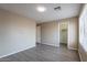This bedroom has modern gray flooring and light tan walls, with a view of a walk-in closet at 3765 E Oxford Ln, Gilbert, AZ 85295
