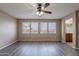 Empty room with wood-look floors, a ceiling fan, and bathroom access at 3765 E Oxford Ln, Gilbert, AZ 85295