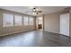 Empty room featuring wood-look floors, ceiling fan, and bathroom access at 3765 E Oxford Ln, Gilbert, AZ 85295