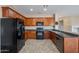 Contemporary kitchen featuring stainless steel appliances, dark countertops, tile floor and wood cabinetry at 3765 E Oxford Ln, Gilbert, AZ 85295