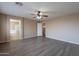 Spacious main bedroom with wood-look floors, ceiling fan, and en-suite bathroom at 3765 E Oxford Ln, Gilbert, AZ 85295