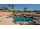 A relaxing backyard swimming pool surrounded by mature palm trees at 3765 E Oxford Ln, Gilbert, AZ 85295