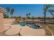 Private backyard pool featuring a rock spa and surrounded by lush tropical plants and mature palm trees at 3765 E Oxford Ln, Gilbert, AZ 85295
