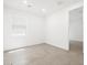 Bright bedroom showcasing a neutral-toned tiled floor and a window at 4226 W Lisa Ln, San Tan Valley, AZ 85144