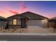 Inviting single-story home with a brick driveway, two-car garage, and desert landscaping at 4226 W Lisa Ln, San Tan Valley, AZ 85144