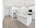 Modern kitchen with white cabinets, stainless steel appliances, and large center island at 4226 W Lisa Ln, San Tan Valley, AZ 85144