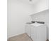 Bright laundry room with white appliances and open shelving at 4226 W Lisa Ln, San Tan Valley, AZ 85144