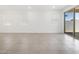 Expansive living room featuring tile floors, ample natural light, and sliding glass doors leading to the patio at 4226 W Lisa Ln, San Tan Valley, AZ 85144