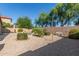 A relaxing backyard with desert landscaping and view of the pool at 43121 W Sunland Dr, Maricopa, AZ 85138