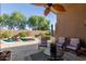 Beautiful outdoor living space with lush landscaping, mature trees, and a luxurious private pool at 43121 W Sunland Dr, Maricopa, AZ 85138