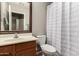 Cozy bathroom with wood-tone cabinets, a single sink, and a shower-tub combo at 43121 W Sunland Dr, Maricopa, AZ 85138