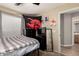 Bedroom with view to the ensuite bath and open door with natural light at 43121 W Sunland Dr, Maricopa, AZ 85138