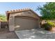 Well-maintained single-story home with desert landscaping, and a two-car garage at 43121 W Sunland Dr, Maricopa, AZ 85138