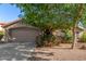 Charming single-story home with a well-manicured front yard and a two-car garage at 43121 W Sunland Dr, Maricopa, AZ 85138